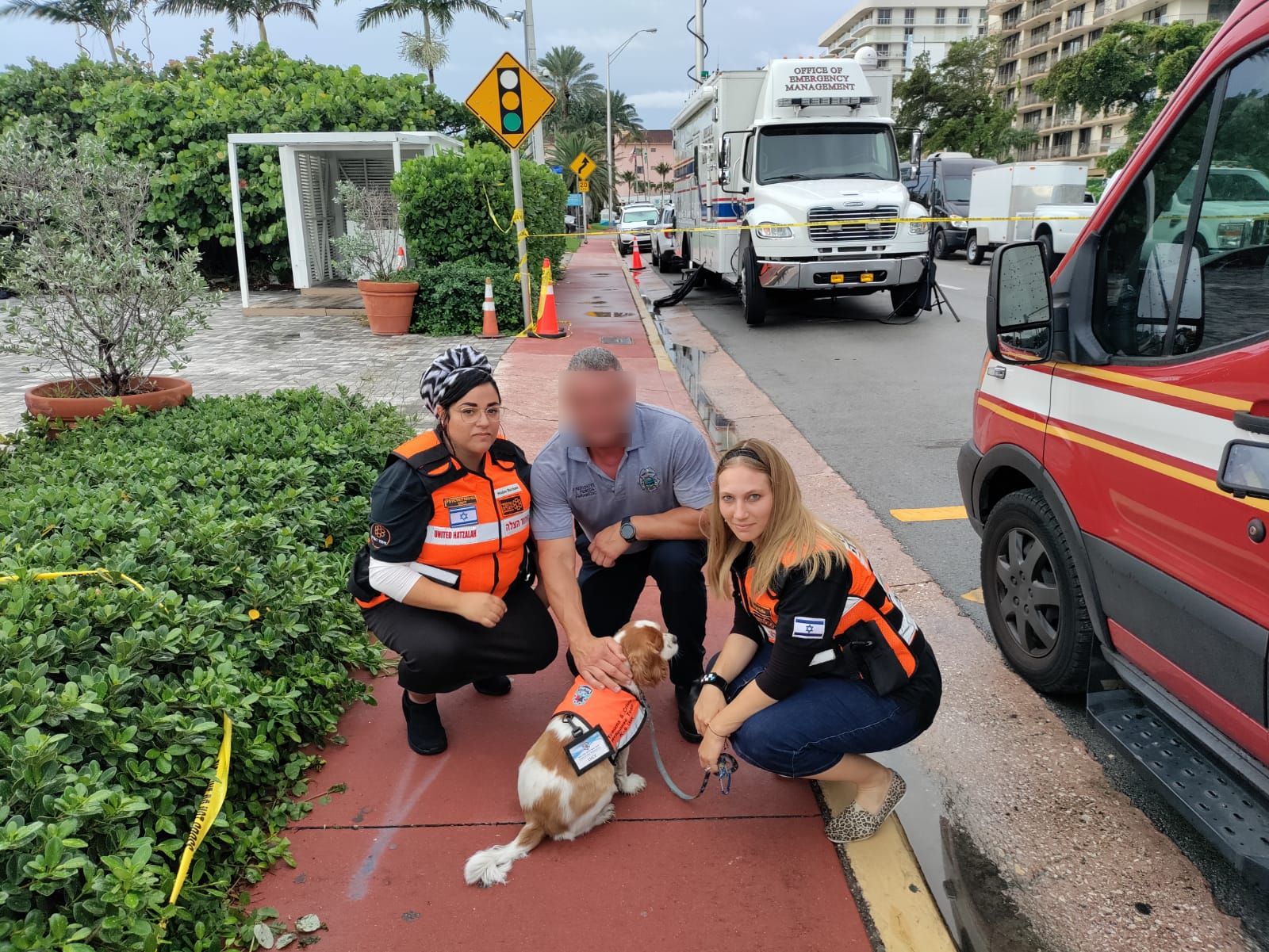 A firefighter coming from the scene stops to pet Lucy censored 1
