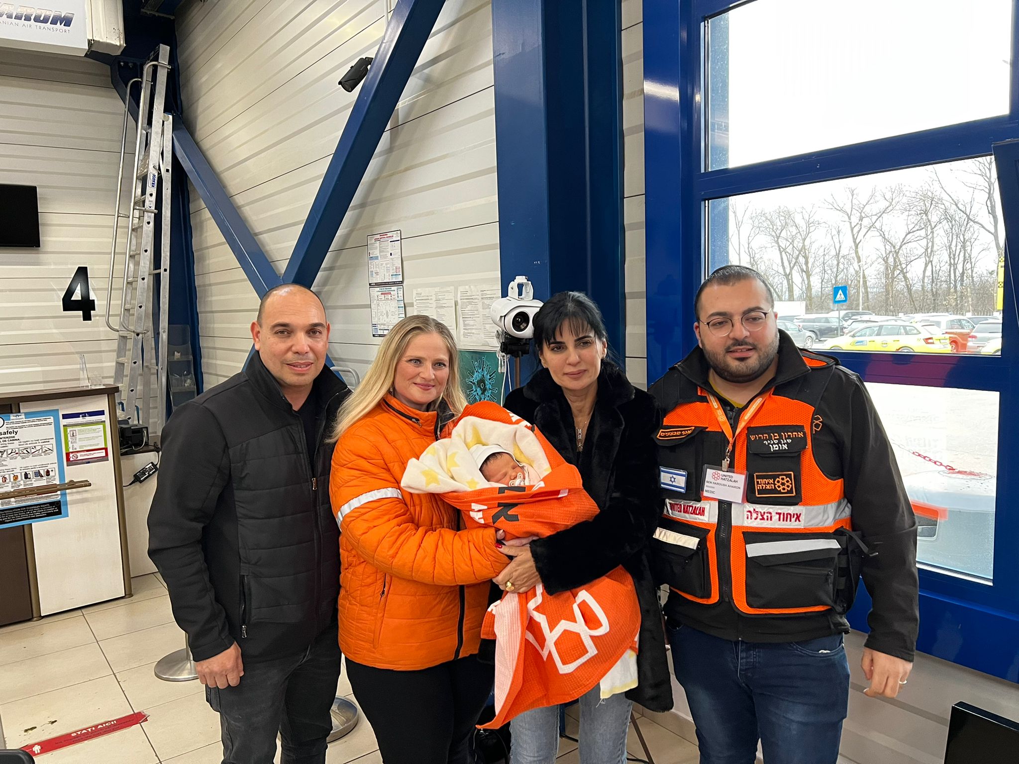 Aharon and Vicky with presenting the first baby to his Israeli parents at the airport in Romania