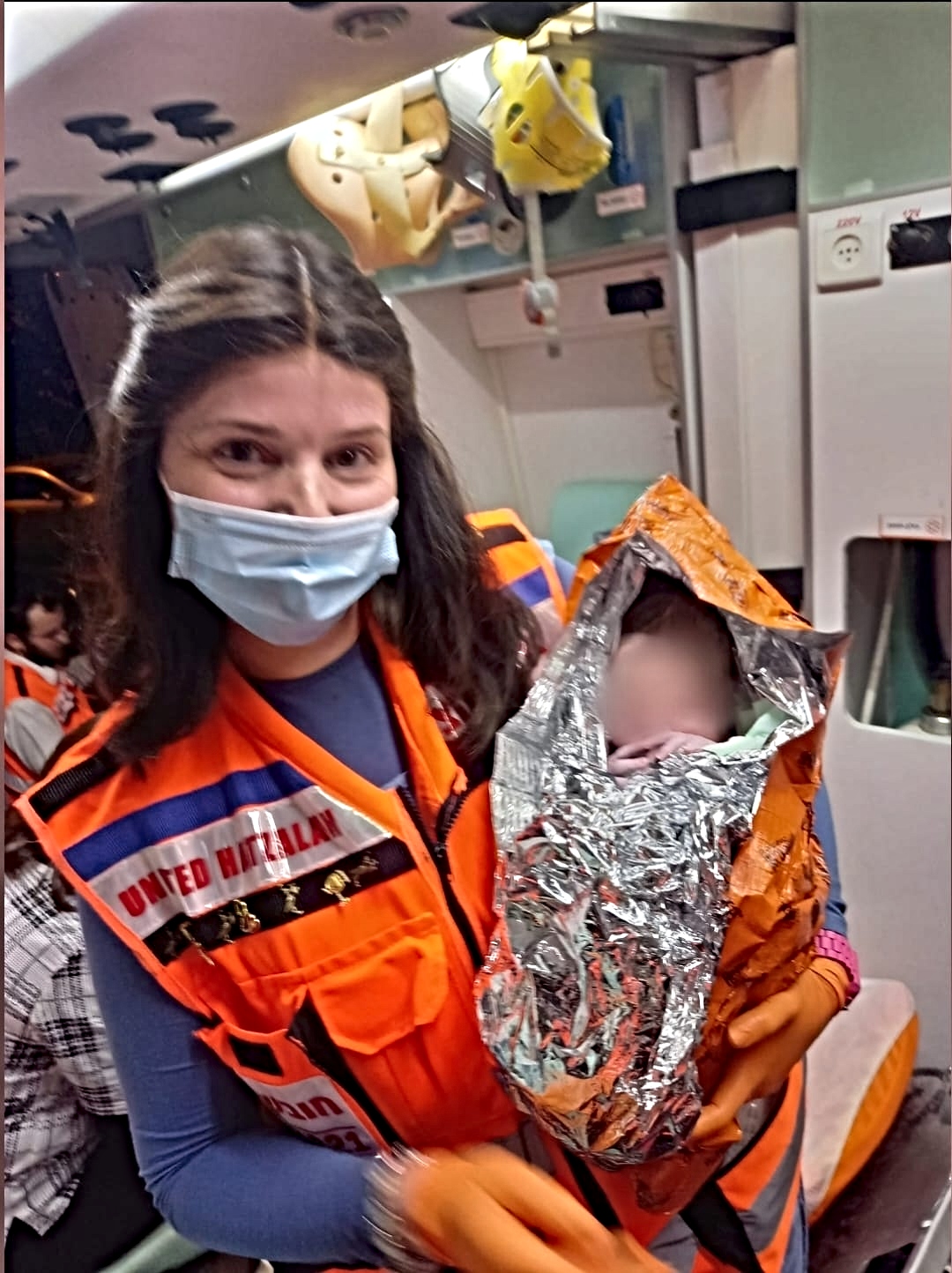 Bat Sheva Gross holding newborn infant 1