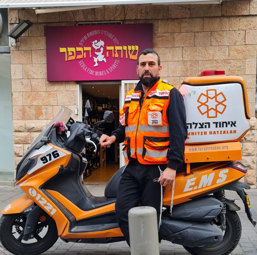 Chezi Roth with his ambucycle in front of his store 1 1