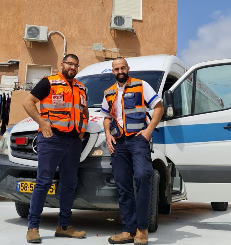 Farok left and Khaled right in front of one of their companys ambulances