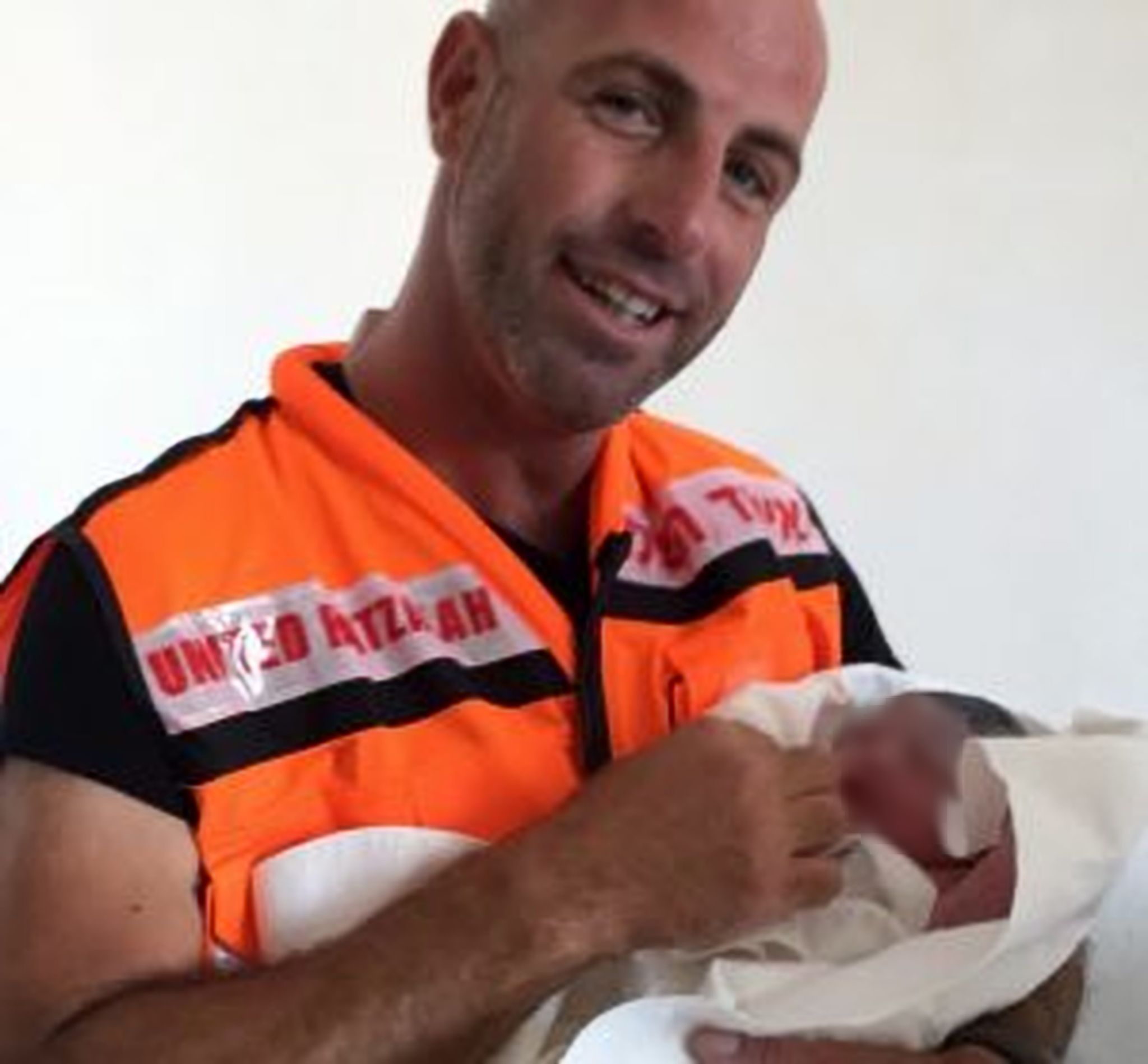 Koby Absturdy with baby he delivered