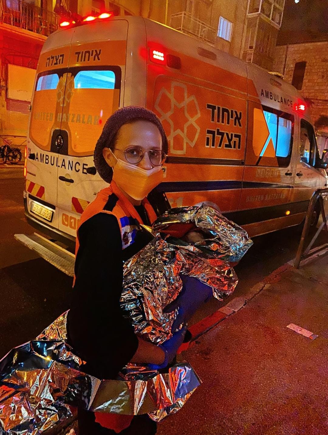 Leah Einhorn holding a baby she just helped deliver illustration