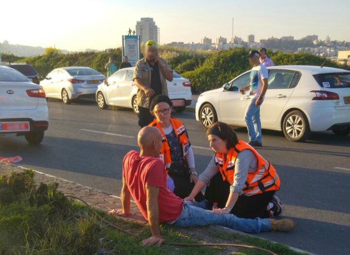 Psychotrauma and Crisis Response Unit members treat man in emotional distress after he witnessed a bus bombing in Jerusalem censored 1 1