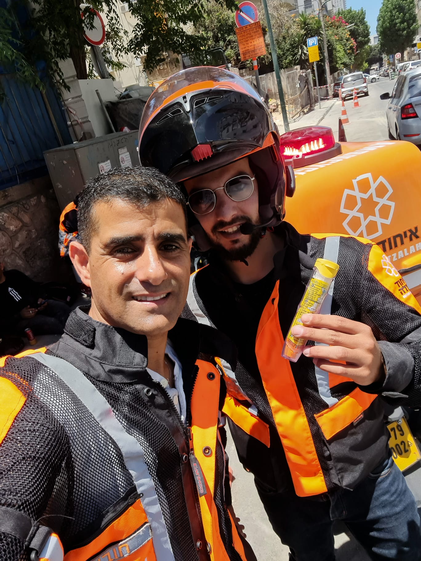Ron left giving Aharon right his new EpiPen after the incident on Yigal Allon Street in Tel Aviv on Tuesday 1