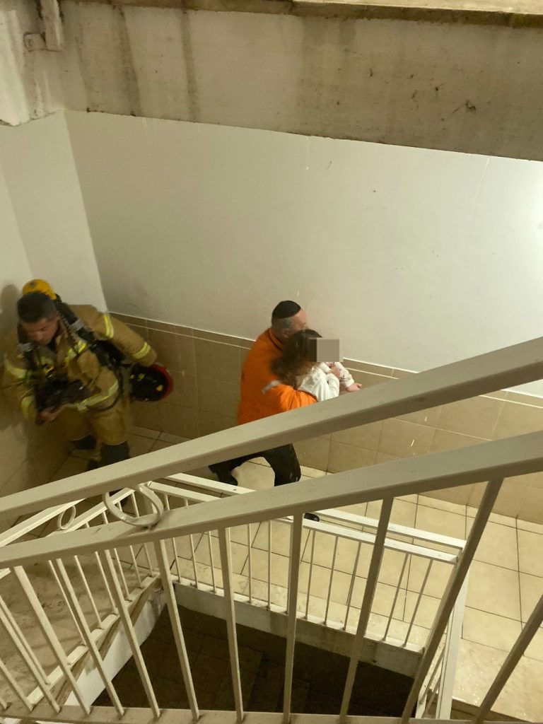 Yechezkel Even carrying a child to safety yesterday in Har Homa 2 768x1024 1