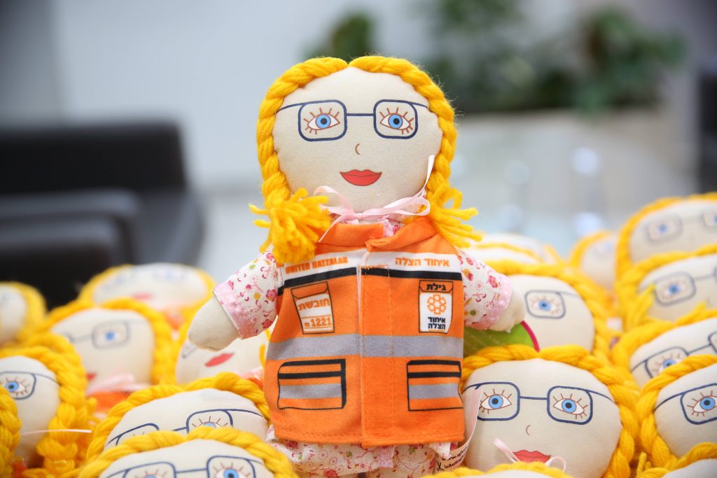 The doll looks like the late Gilat Eisenmann and is donning a United Hatzalah vest 1 1024x683 1