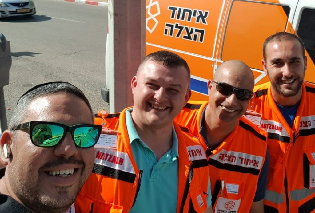 Shlomi Asraf right together with other United Hatzalah volunteers on an ambulance shift