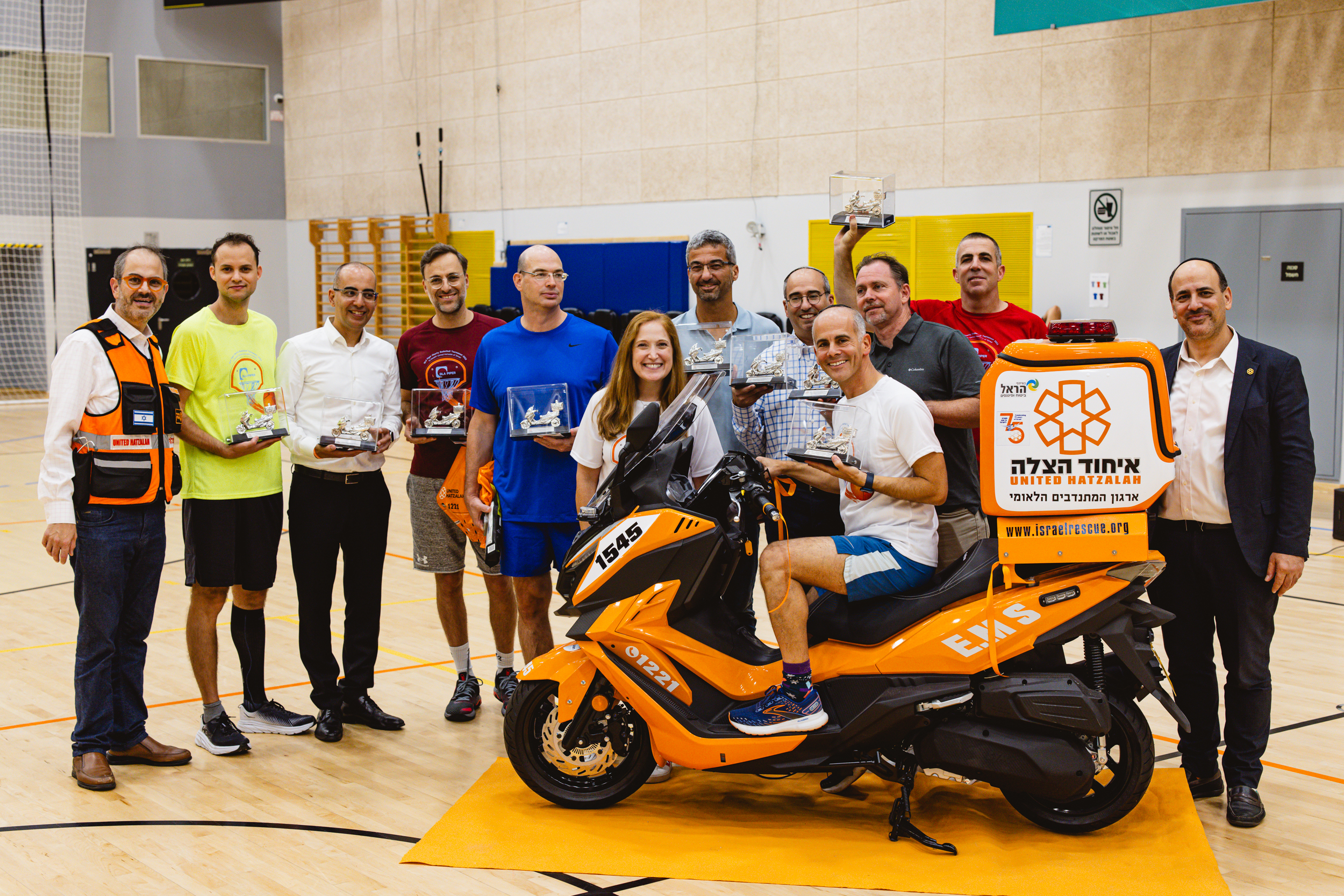 Naomi Maryles Jeremy Lustman on the ambucycle Eli Beer left Eli Pollak right and the partners from the participating l