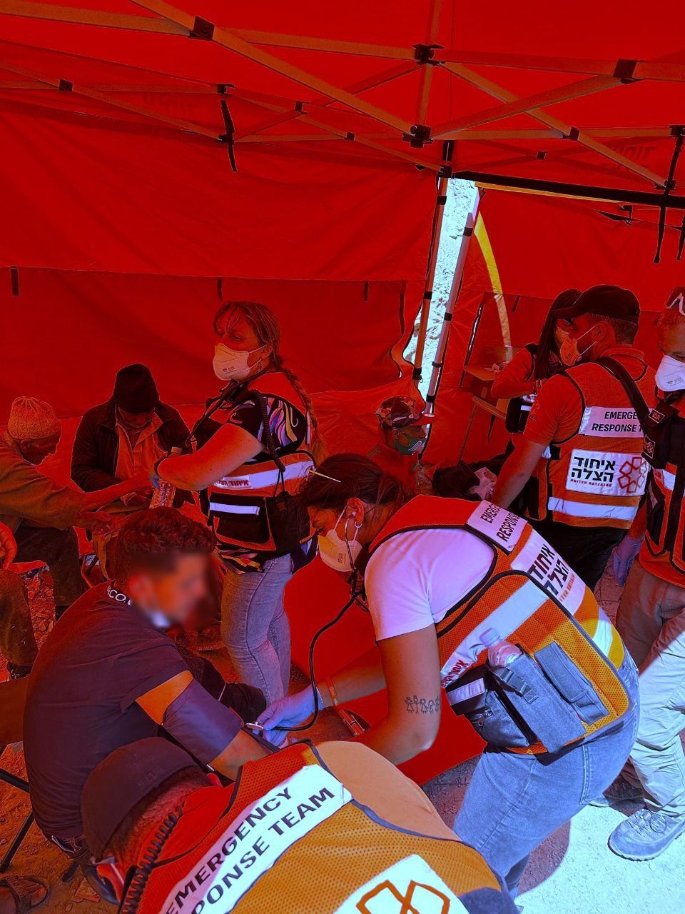 United Hatzalah doctors paramedics and EMTs treating injured and ill people from Imi NTala at the medical clinic censored