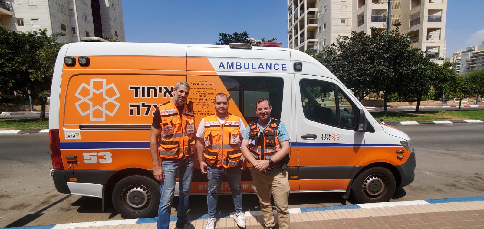 Widawsky right Eddie Center Wilick left standing in front of an ambulance