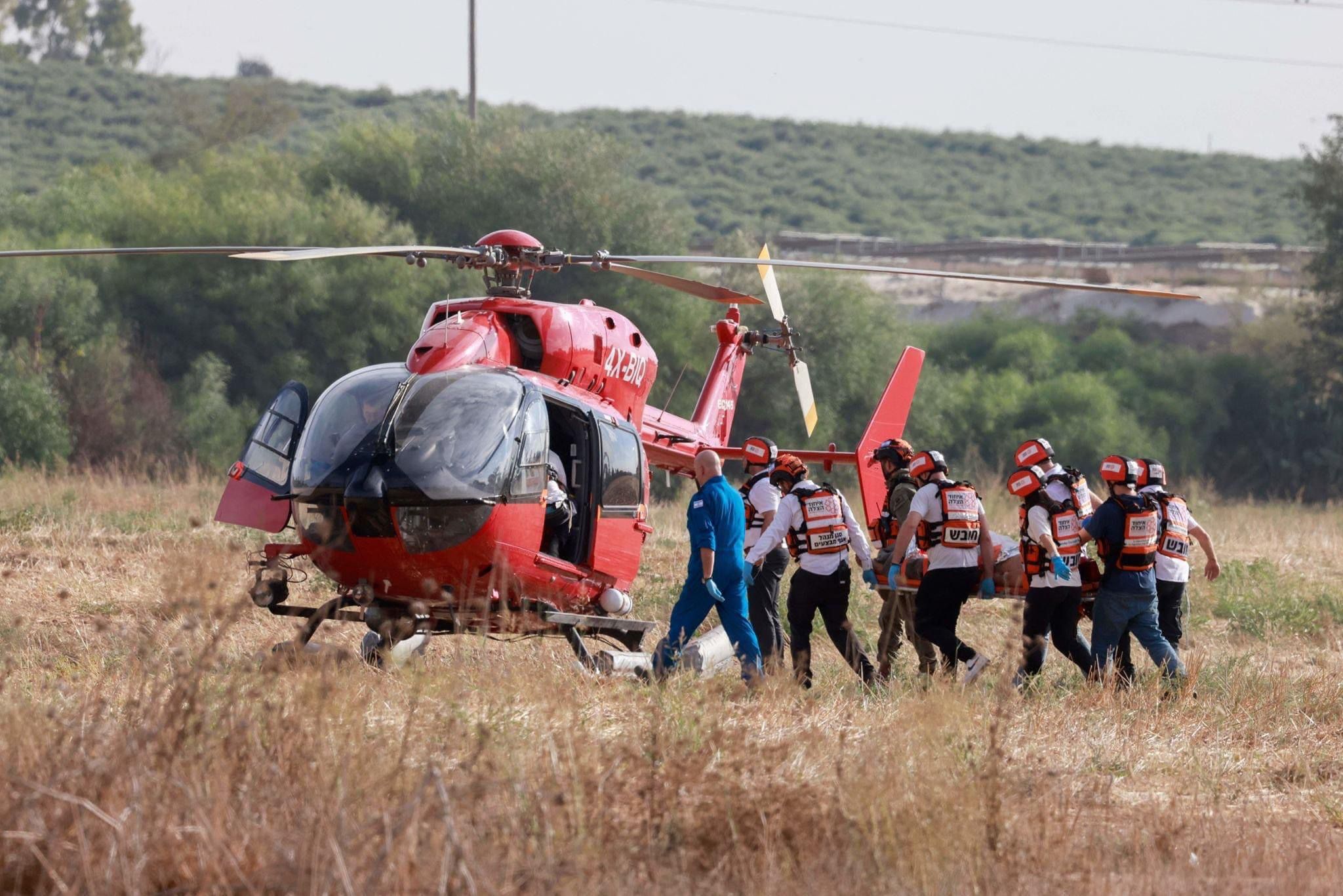 IDF soldiers together with UH volunteers bring an injured patient to one of United Hatzalahs helicopters for emergency medevac from the Gaza border 1